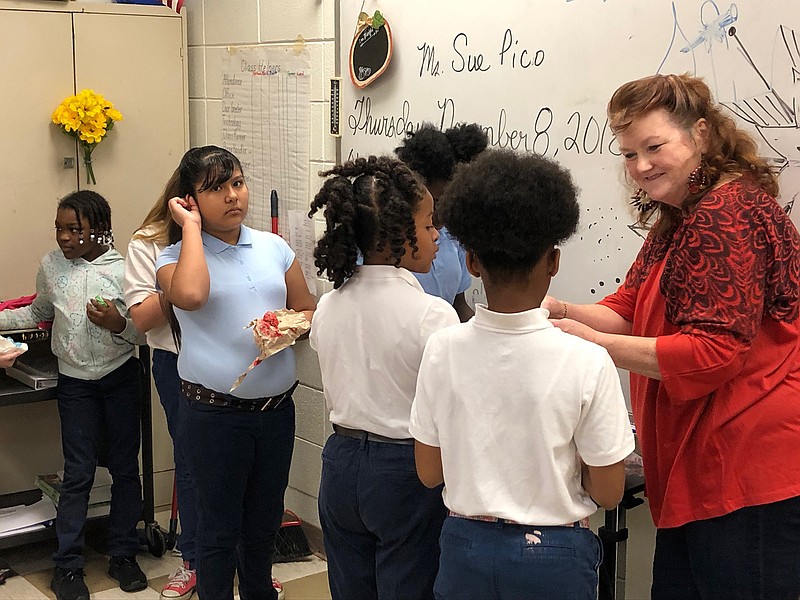 AIE artist Sue Pico assists students with drying their dyed eggs in an unique Ukrainian style. More than 120 students learned how to use wax and dyes to create unique ornaments from egg shells. (Submitted photo)

