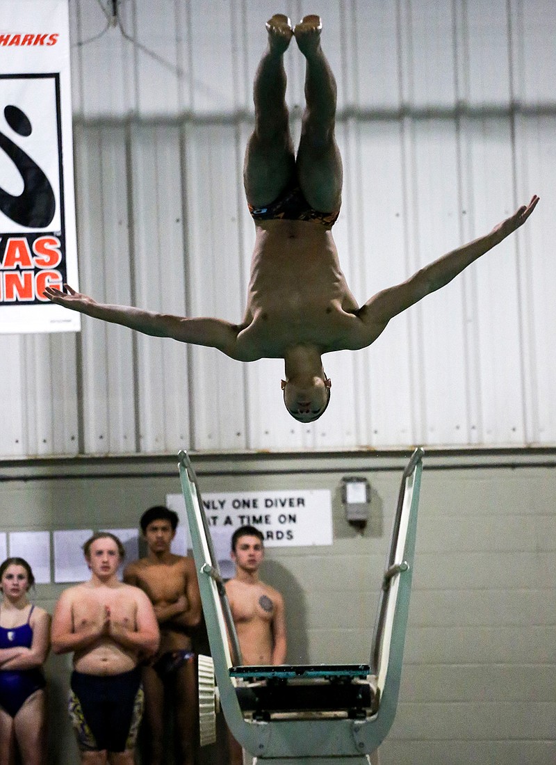 Robert Brand of Texas High School holds form as he completes a dive during the first day of the Northeast Texas TISCA Swimming and Diving Invitational on Thursday at the Texarkana College Natatorium. The Tigersharks are hosting 22 teams for the competition. The second round of preliminaries starts at 3:30 p.m. today, with finals set for 10:45 a.m. Saturday. Entry is free.