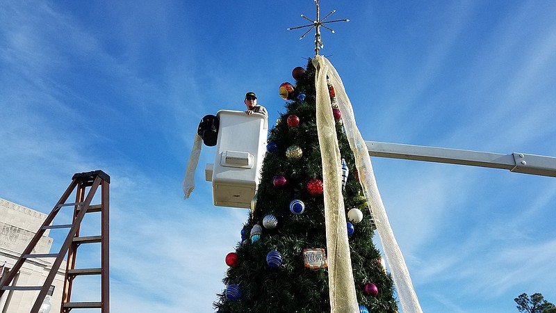  A Texarkana, Texas, public works crew decorates the community Christmas tree Friday downtown.