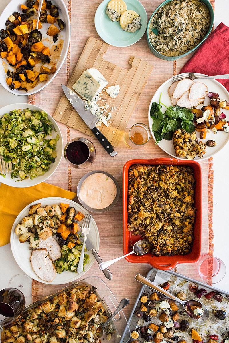 This October 2017 photo provided by Katie Workman shows food on the table at her apartment in New York. When you are making a big Thanksgiving dinner getting as much done ahead of time - and enlisting as much help from family and friends as possible — makes these epic meals much more enjoyable. (Sarah Crowder/Katie Workman via AP)