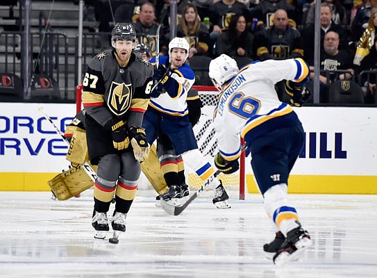 Blues defenseman Joel Edmundson shoots the puck against Golden Knights left wing Max Pacioretty during the second period of Friday night's game in Las Vegas.