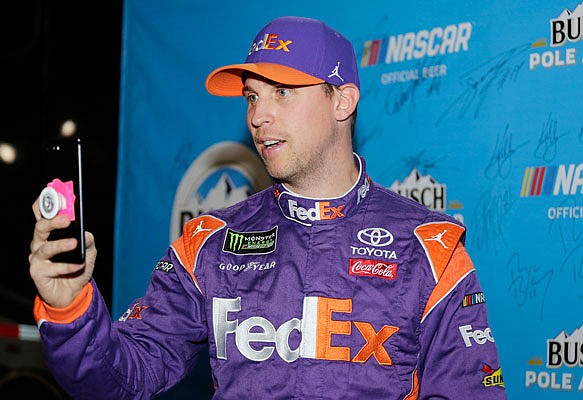 Denny Hamlin takes a selfie Friday after winning the pole position during qualifying for the NASCAR Cup Series race at the Homestead-Miami Speedway in Homestead, Fla.
