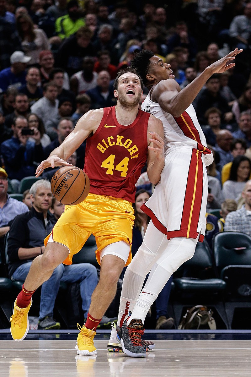 Indiana Pacers forward Bojan Bogdanovic (44) is fouled by Miami Heat center Hassan Whiteside (21) during the second half of an NBA basketball game in Indianapolis, Friday, Nov. 16, 2018. (AP Photo/AJ Mast)