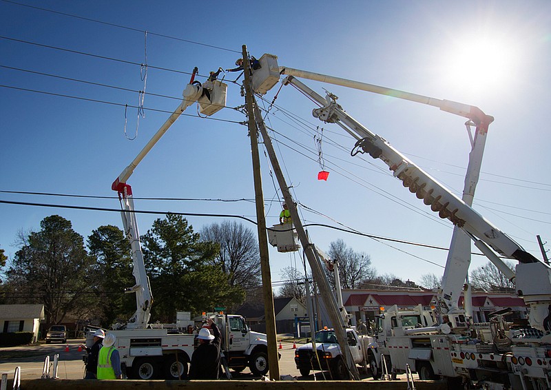 In this 2014 photo, Southwestern Electric Power Co. crews install a power pole in Texarkana, Texas. SWEPCO's parent company, American Electric Power, is one of six publicly traded companies that energize the Texarkana Industrial Index. (File photo)
