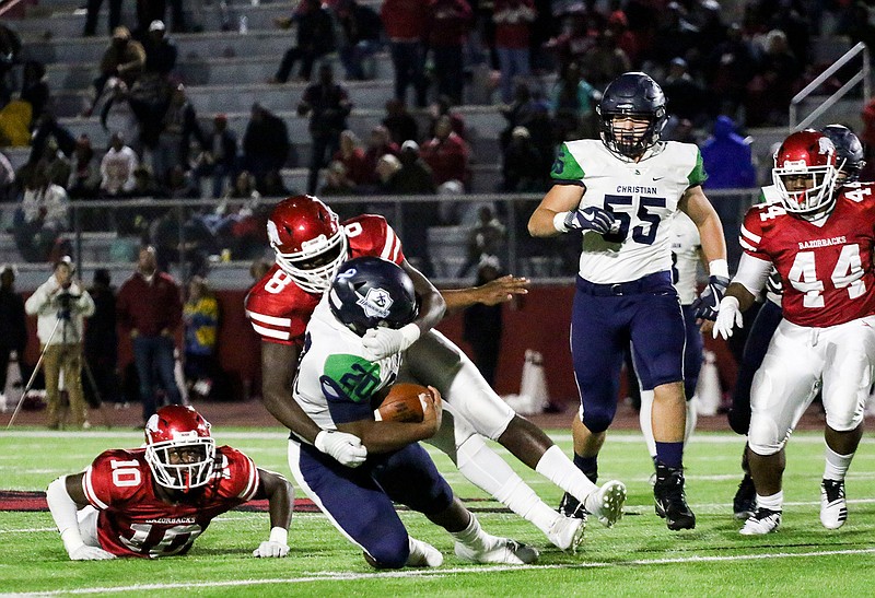 Arkansas High defensive lineman Dreylon Morine (8) puts the brakes on Little Rock Christian running back Kendel Givens (20) on Friday at Razorback Stadium in Texarkana, Ark.