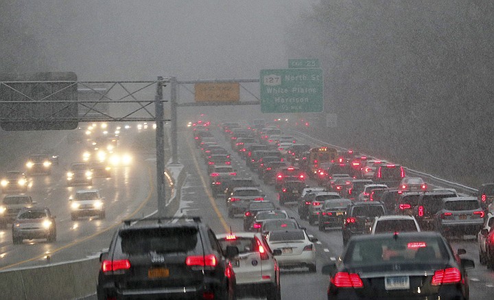 This Thursday, Nov. 15, 2018 photo shows southbound traffic on the Hutchinson River Parkway, in Harrison, NY. The first snowfall of the season lingered Friday in the Northeast as thousands of exhausted commuters pointed their fingers at politicians and meteorologists for leaving them creeping along highways or stuck in mass transit hubs. (Frank Becerra Jr./The Journal News via AP)