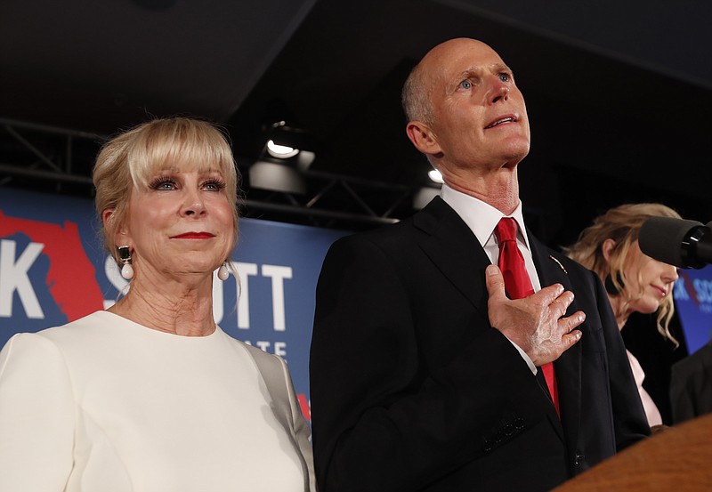 FILE- In this Wednesday, Nov. 7, 2018, file photo Republican Senate candidate Rick Scott speaks with his wife Ann by his side at an election watch party in Naples, Fla. Scott is leading incumbent Sen. Bill Nelson in the state’s contentious Senate race. Official results posted by the state on Sunday, Nov. 18, showed Scott ahead of Nelson following legally-required hand and machine recounts. State officials will certify the final totals on Tuesday. (AP Photo/Wilfredo Lee, File)
