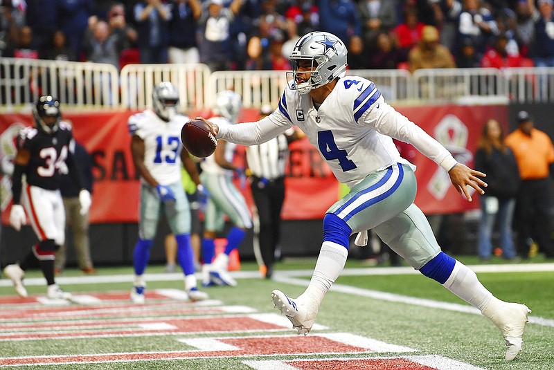 Dallas Cowboys quarterback Dak Prescott celebrates his touchdown against the Atlanta Falcons during the second half Sunday, Nov. 18, 2018, in Atlanta. 