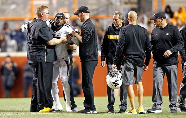 Missouri wide receiver Richaud Floyd is helped to the sideline after being injured in the second half of Saturday's game against Tennessee in Knoxville, Tenn.