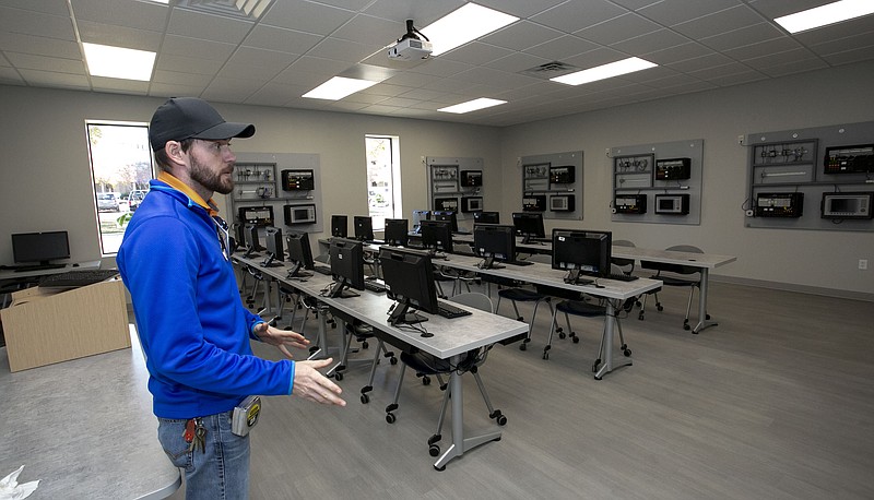 Texarkana College industrial training coordinator Thomas Holt explains the purpose of the equipment within one of the new rooms at the Betty & Buddy Ledwell Workforce Training Center on Friday at Texarkana College. The center's dedication is scheduled for 11 a.m. Nov. 27. The $1.5 million building will house all the college's workforce programs, including the construction technology department, which has been at the Texarkana Independent School District property. The workforce center is named after a well-known local family business established in 1946, which has flourished and has a strong presence in the community. The company specializes in custom-manufactured bodies, trucks, trailers and parts. The groundbreaking for the center was held in February.