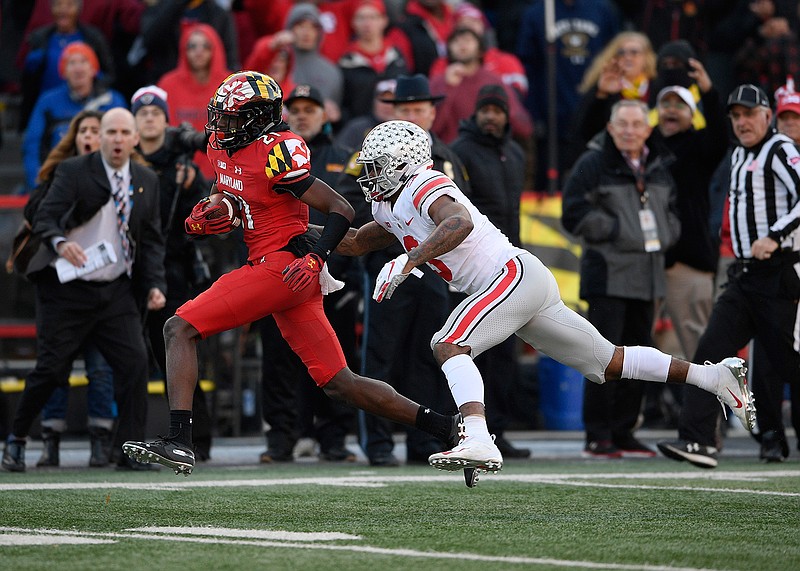 Maryland wide receiver Darryl Jones (21) runs with the ball against Ohio State cornerback Damon Arnette (3) during the second half of an NCAA football game, Saturday, Nov. 17, 2018, in College Park, Md. Ohio State won 52-51 in overtime. (AP Photo/Nick Wass)