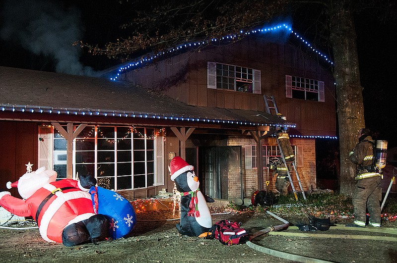 Members of the Texarkana, Texas, Fire Department search for the source of a house fire in December 2014. Experts say heating equipment is a leading cause of house fires.
