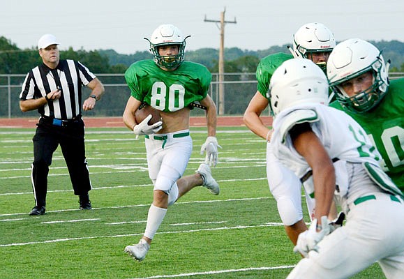 Blair Oaks wide receiver Ben Thomas runs with the ball during a preseason scrimmage at the Falcon Athletic Complex.