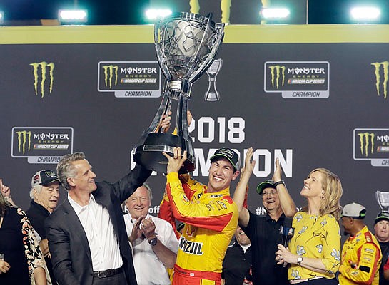 Joey Logano holds the trophy after winning the NASCAR Cup Series Championship race Sunday at the Homestead-Miami Speedway in Homestead, Fla.