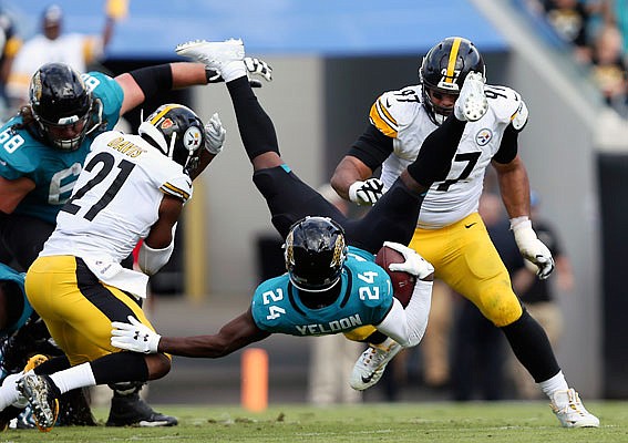 Jaguars running back T.J. Yeldon is flipped on a run during Sunday's game against the Steelers in Jacksonville, Fla.