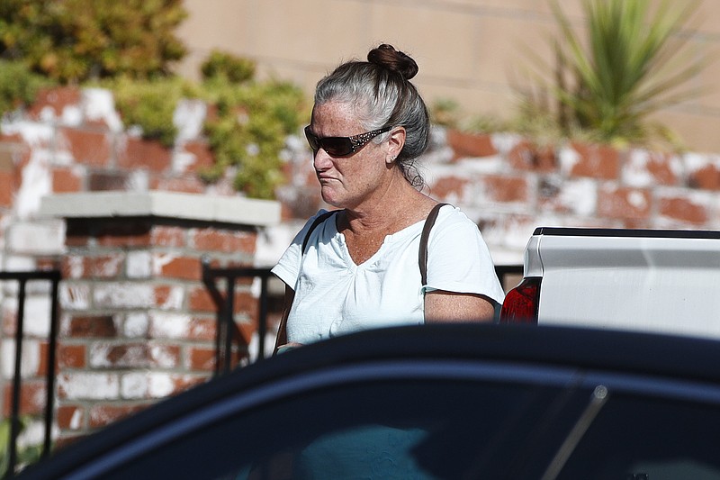 FILE - In this Thursday, Nov. 8, 2018, file photo, Colleen Long, mother of shooting suspect David Ian Long, leaves her house in Newbury Park, Calif. If authorities have concluded why Ian David Long shot and killed 12 people at a Southern California bar, they aren't sharing, and his family isn't talking, either. That has left a community still in mourning to wonder why, but also ask who was the man who shattered the sense of security in the Los Angeles suburb of Thousand Oaks? (AP Photo/Jae C. Hong, File)