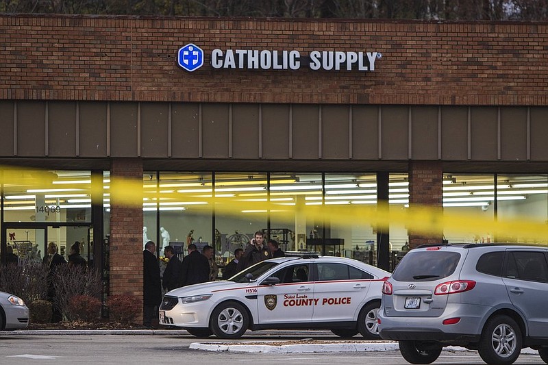 Authorities investigate the scene at a Catholic Supply store where a gunman went into the religious supply store, sexually assaulted at least one woman and shot a woman in the head, Monday, Nov. 19, 2018, in Ballwin, Mo. (Johanna Huckeba/St. Louis Post-Dispatch via AP)