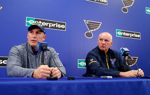 Craig Berube (left) speaks during a news conference Tuesday along side Blues general manager Doug Armstrong after Berube was named interim head coach of the team in St, Louis.