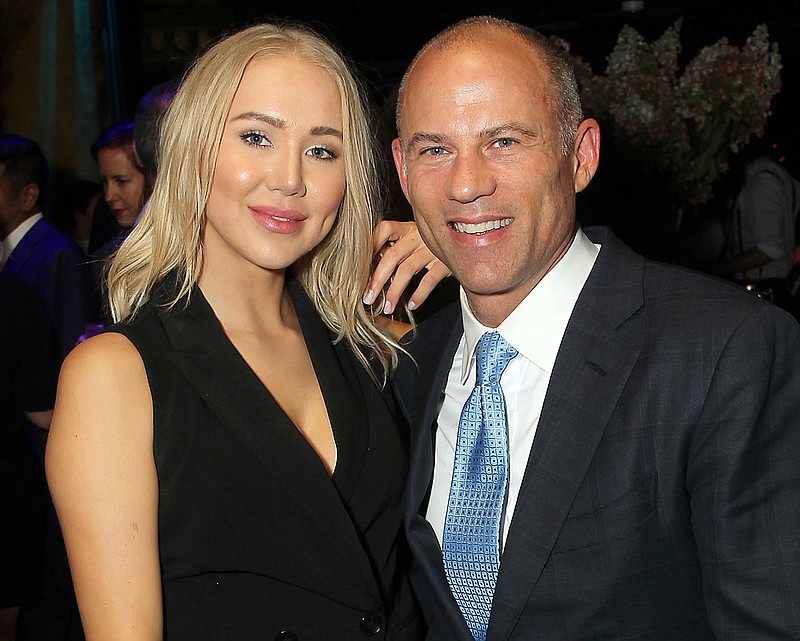 In this September 2018 photo, attorney Michael Avenatti, right, poses with Mareli Miniutti for a photo at a party in New York. Miniutti alleges that Avenatti dragged her across the floor of his Los Angeles apartment after an argument over money, according to court documents obtained Tuesday, Nov. 20, 2018, by The Associated Press. Avenatti, who was arrested the week before on a felony domestic violence charge, called the allegations "completely false." He's scheduled to appear in court in December 2018. (Marion Curtis/StarPix via AP)