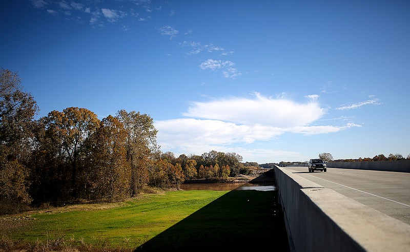 A car drives Wednesday on the new Red River Bridge on Interstate 30 near Fulton, Ark. The Arkansas Department of Transportation held ribbon-cutting ceremonies Wednesday to celebrate the completion of two bridges and a highway overlay project in Texarkana, Ark. The project replaced the Red River Bridge and the Hurricane Creek Bridge in Little River County.