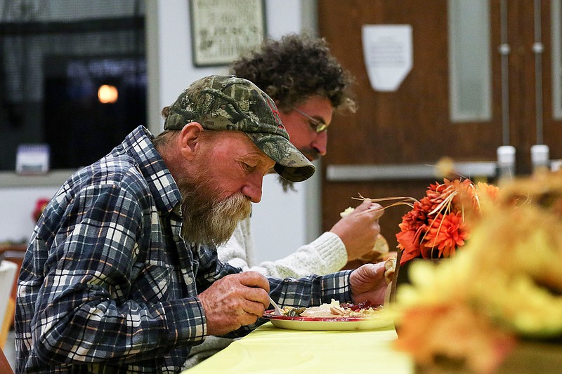 Dwight Clark and James Scarl eat their Thanksgiving dinners at The Salvation Army's Center of Hope on Thursday in Texarkana, Ark. The Salvation Army gathered enough food to feed the residents and the homeless of Texarkana. 