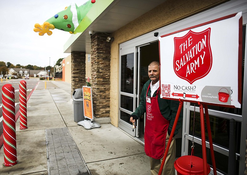 Clifford Bertlow stands and rings a bell for The Salvation Army donation stand in front of Walmart Neighborhood Market on Richmond Road on Friday in Texarkana, Texas.