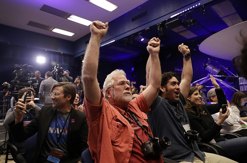 People at NASA's Jet Propulsion Laboratory in Pasadena, Calif., celebrate as the InSight lander touches down on Mars on Monday, Nov. 26, 2018. (AP Photo/Marcio Jose Sanchez)