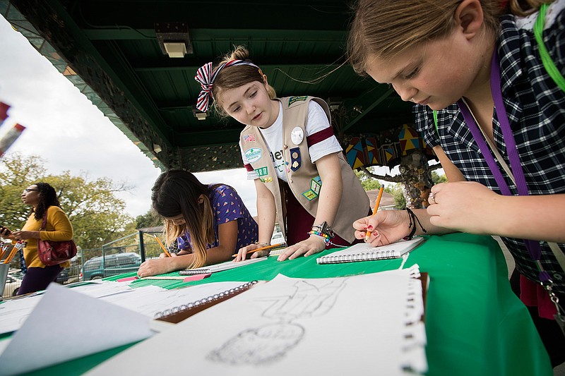 Izzy, 13, a Girl Scouts Troop 14527 Cadette, helps Girl Scouts Valentina Urteaga, left, 9, and Grace Eppley, 10, right, learn how to draw Nov. 17, 2018, in Houston. Izzy's "Recovery Through Art" event focused on teaching other girls techniques to recover from traumatic events by expressing themselves through the arts.
