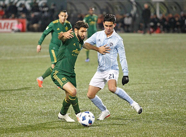 Portland's Diego Valeri (left) works against Sporting Kansas City's Felipe Gutierrez during Sunday's first leg of the MLS Western Conference final in Portland, Ore. The two teams played to a scoreless tie.