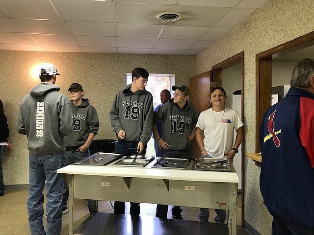 Dason Strange, Ethan Gerlach, Ross Gerlach, Josh Nott and Jarrett Gorman serve at the senior dinner Nov. 4 in Jamestown.