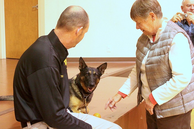 K9 Officer Mizzou sits beside Sheriff Tony Wheatley Nov. 21 at the retired teacher's meeting, where Wheatley explained how K9 officers are trained and gave a history of Mizzou's life. Mizzou even demonstrated her narcotic identifying skills for the retired teachers.