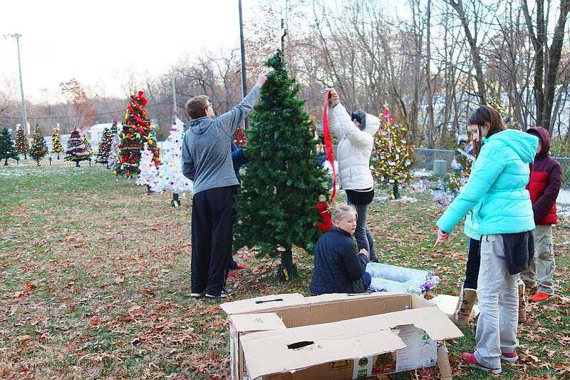 <p>Helen Wilbers/FULTON SUN</p><p>A group of students and parents from Kingdom Christian Academy flock around a tree in the Field of Joy. The field, which benefits Salvation Army, lights up at 5:30 p.m. tonight. Check out the community calendar for many more holiday events, including the Fulton Jaycees’ Christmas Parade at 1 p.m. Saturday.</p>