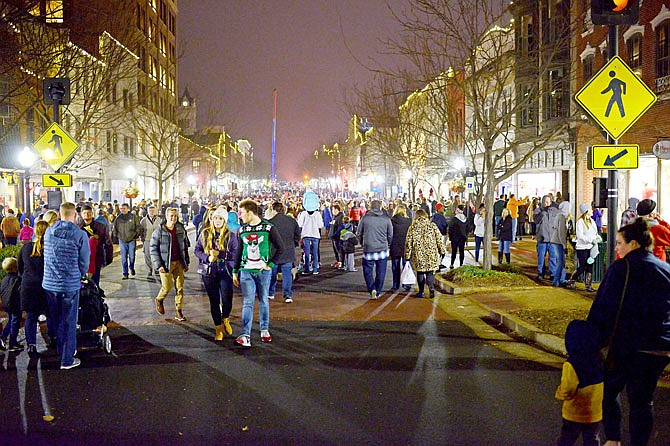 Guests crowd on East High Street on Friday, Nov. 30, 2018, during the annual Living Windows event in downtown Jefferson City.