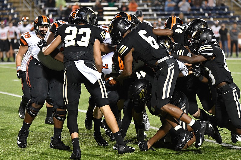 Pleasant Grove's Dylan Hopkins and Nick Martin tackle Gilmer's Brannon Webb in the first half of their Class 4A, Division II regional quarterfinal playoff game Friday night at Eagle Stadium in Allen, Texas. (Photo by Kevin Sutton)