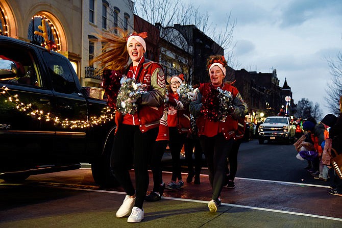 Jefferson City High School cheerleaders chant as they walk down the street as part of the 79th annual Jaycees Christmas Parade on Saturday in downtown Jefferson City.
