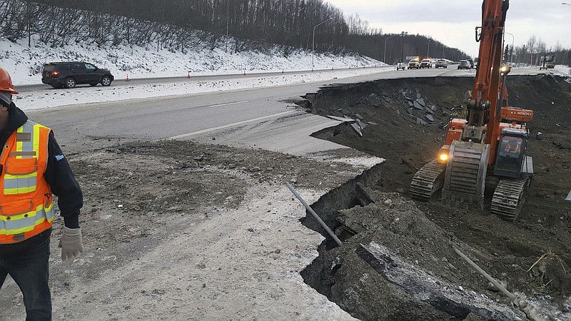 This photo provided by Chris Riekena shows excavation work being conducted Saturday, Dec. 1, 2018, near the Mirror Lake exit of the Glenn Highway near Eklutna, Alaska, to make the highway ready for repaving. The highway was heavily damaged in several spots following a magnitude 7.0 earthquake on Nov. 30, 2018. (Chris Riekena via AP)