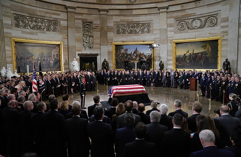 The flag-draped casket of former President George H.W. Bush lies in state in the Capitol Rotunda in Washington, Monday, Dec. 3, 2018. (AP Photo/Pablo Martinez Monsivais/Pool)