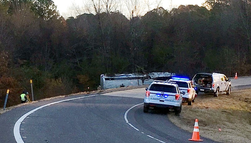 Emergency personnel work at the scene where a charter bus that was carrying a youth football team from Tennessee crashed early Monday, Dec. 3, 2018, near Benton, Ark. Arkansas State Police said the bus overturned along Interstate 30 while carrying the team from Texas to Memphis, Tenn.