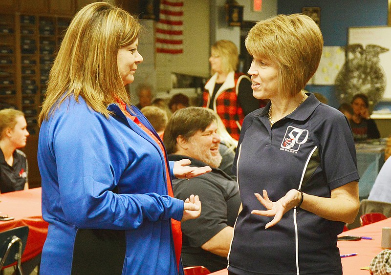 Kelli Engelbrecht, right, and Shelly Henderson, a digital instructor at Eldon, chat Wednesday during the 50th year celebration appreciation dinner at the Eldon Career Center. Engelbrecht, who is the director at Eldon, will be retiring July 1, after 31 years.