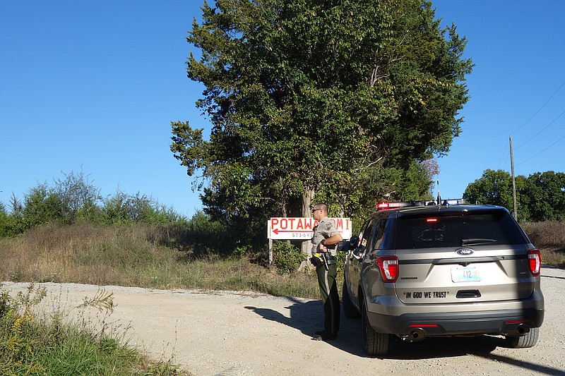 A Callaway County Sheriff's Office deputy gazes into the Potawatami Campground, an area east of Fulton where a helicopter crash Oct. 17, 2018, left one person dead.