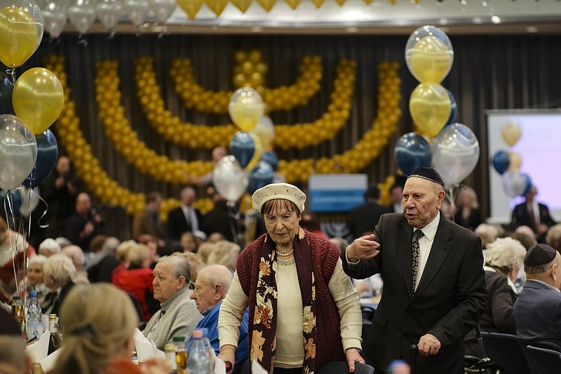 Two holocaust survivors arrive for the International Holocaust Survivors Night of the Jewish Community in Berlin, Germany, Tuesday, Dec. 4, 2018. (AP Photo/Markus Schreiber)