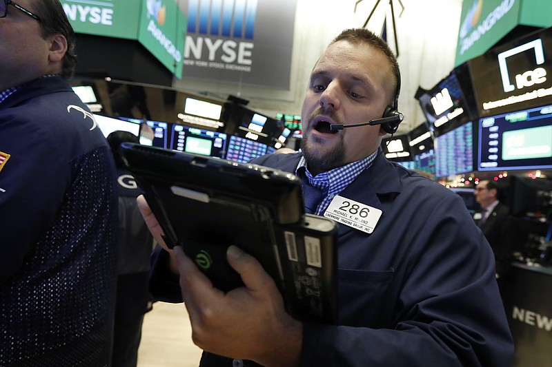 FILE- In this Nov. 28, 2018, file photo trader Michael Milano works on the floor of the New York Stock Exchange. The U.S. stock market opens at 9:30 a.m. EST on Tuesday, Dec. 4. (AP Photo/Richard Drew, File)