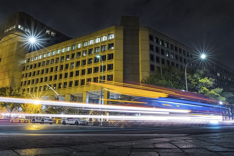 FILE - In this Nov. 1, 2017, file photo, traffic along Pennsylvania Avenue in Washington streaks past the Federal Bureau of Investigation headquarters building. The National Republican Congressional Committee said Tuesday that it was hit with a "cyber intrusion" during the 2018 midterm campaigns and has reported the breach to the FBI. (AP Photo/J. David Ake)