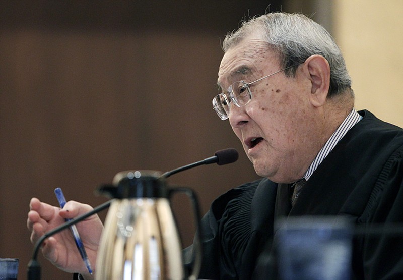 FILE - In this Feb. 13, 2012 file photo, U.S. 9th Circuit Court of Appeals Judge A. Wallace Tashima speaks during arguments in San Francisco. A U.S. appeals court struck down a federal immigration law Tuesday, Dec. 4, 2018, that opponents warned could be used to criminalize a wide range of statements involving illegal immigration. A three-judge panel of the 9th U.S. Circuit Court of Appeals, including Tashima, ruled Tuesday that the law is unconstitutional because it criminalizes a substantial amount of protected speech. (AP Photo/Paul Sakuma, File)