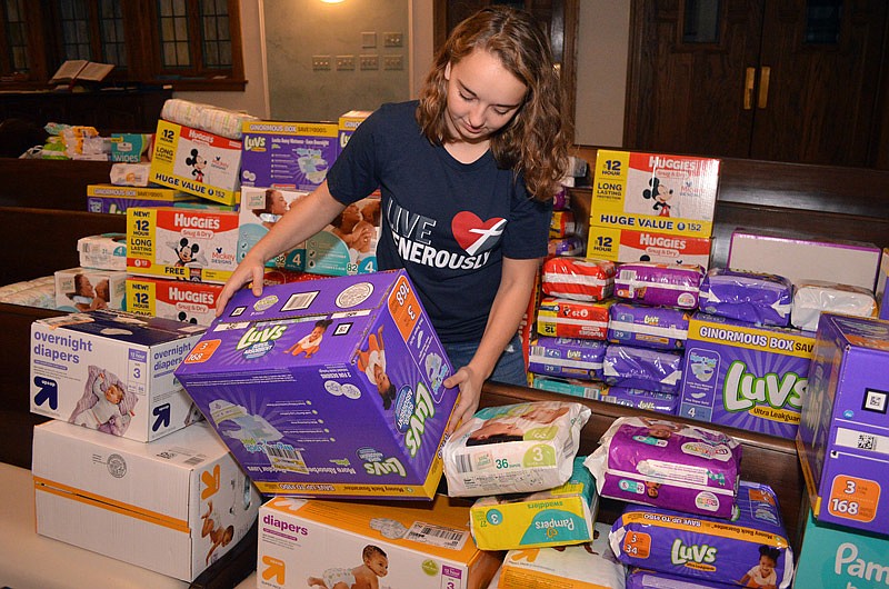 Anna Spalding sorts through donated diapers Friday, Dec. 8, 2017, during the Stuff Santa's Sleigh Drive at First Presbyterian Church in Jefferson City.