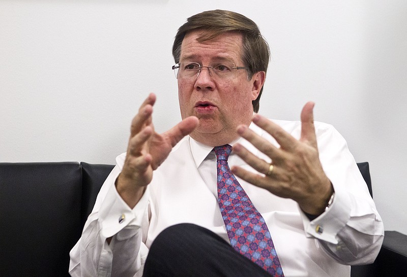 FILE- In this Jan. 11, 2016, file photo Toyota North America CEO Jim Lentz speaks during an interview at the North American International Auto Show in Detroit. Lentz told the Detroit Economic Club Wednesday, Dec. 5, 2018, that car sales fell below 30 percent of sales last month, and he thinks that's close to the bottom. (AP Photo/Tony Ding, File)