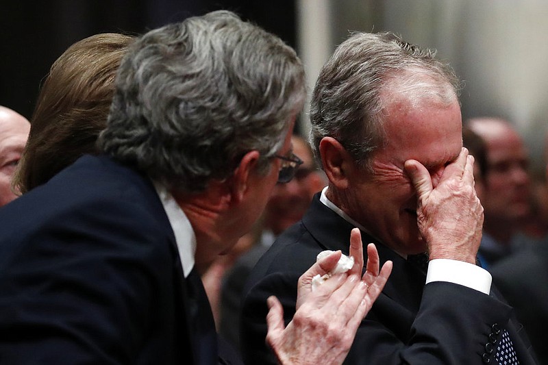Former President George W. Bush, right, cries after speaking during the State Funeral for his father, former President George H.W. Bush, at the National Cathedral, Wednesday, Dec. 5, 2018, in Washington. (AP Photo/Alex Brandon, Pool)
