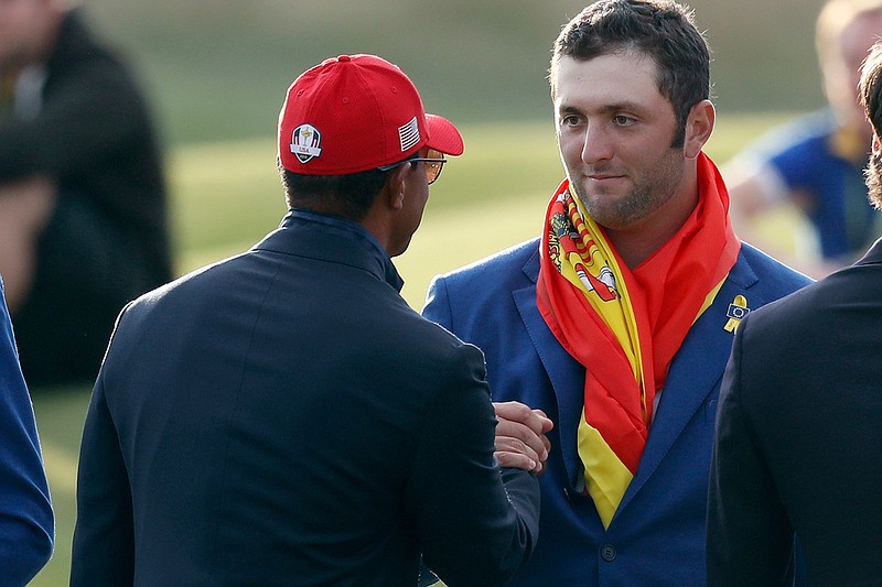 In this Sept. 30, 2018, file photo, Europe's Jon Rahm, right, is congratulated by Tiger Woods during the trophy ceremony after the European team won the 2018 Ryder Cup golf tournament at Le Golf National in Saint Quentin-en-Yvelines, outside Paris, France. Rahm calls Woods his all-time hero and says this was the best moment of his career. (AP Photo/Alastair Grant, File)
