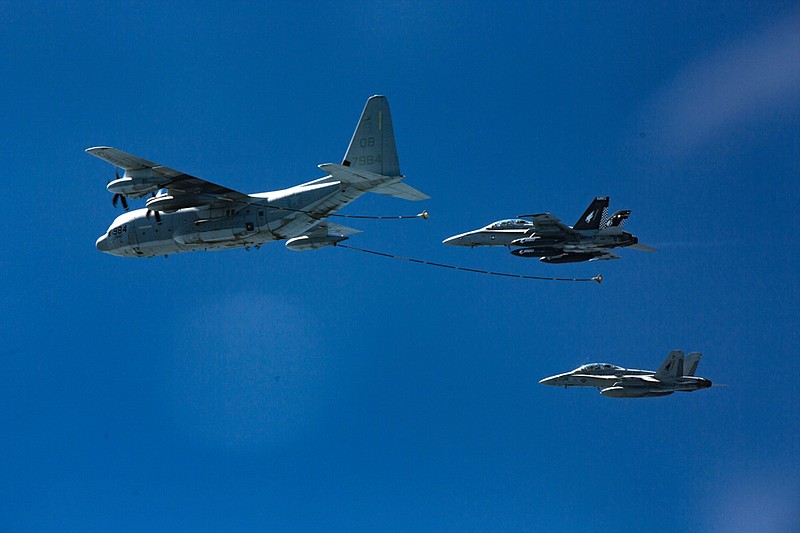 In this Oct. 13, 2016, photo provided by U.S. Marine Corps, two F/A-18D Hornets with Marine All-Weather Fighter Attack Squadron 533 approach a KC-130J with Marine Aerial Refueler Transport Squadron 352 during a Special Purpose Marine Air-Ground Task Force - Crisis Response - Central Command aerial refueling exercise in undisclosed location.  On Thursday, Dec. 6, 2018, two American warplanes crashed into the Pacific Ocean off Japan's southwestern coast after a midair collision,  and rescuers found one of the seven crew members in stable condition while searching for the others, officials said.  The U.S. Marine Corps said that the crash involved an F/A-18 fighter jet and a KC-130 refueling aircraft during regular training after the planes took off from their base in Iwakuni, near Hiroshima in western Japan.  (Cpl. Trever Statz/U.S. Marine Corps via AP)
