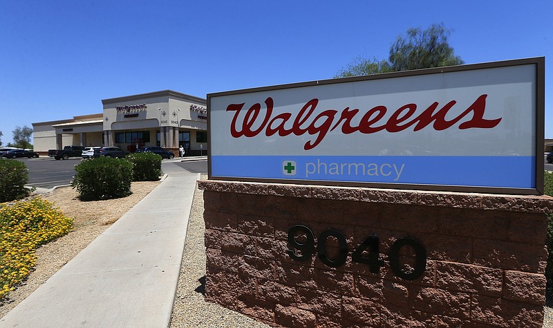 FILE- In this June 25, 2018, file photo shows a Walgreens store in Peoria, Ariz. Walgreens is joining drugstore competitor CVS Health in launching home deliveries for prescriptions nationwide, as stores continue adjusting to a retail world made more customer-friendly by online competition. (AP Photo/Ross D. Franklin, File)